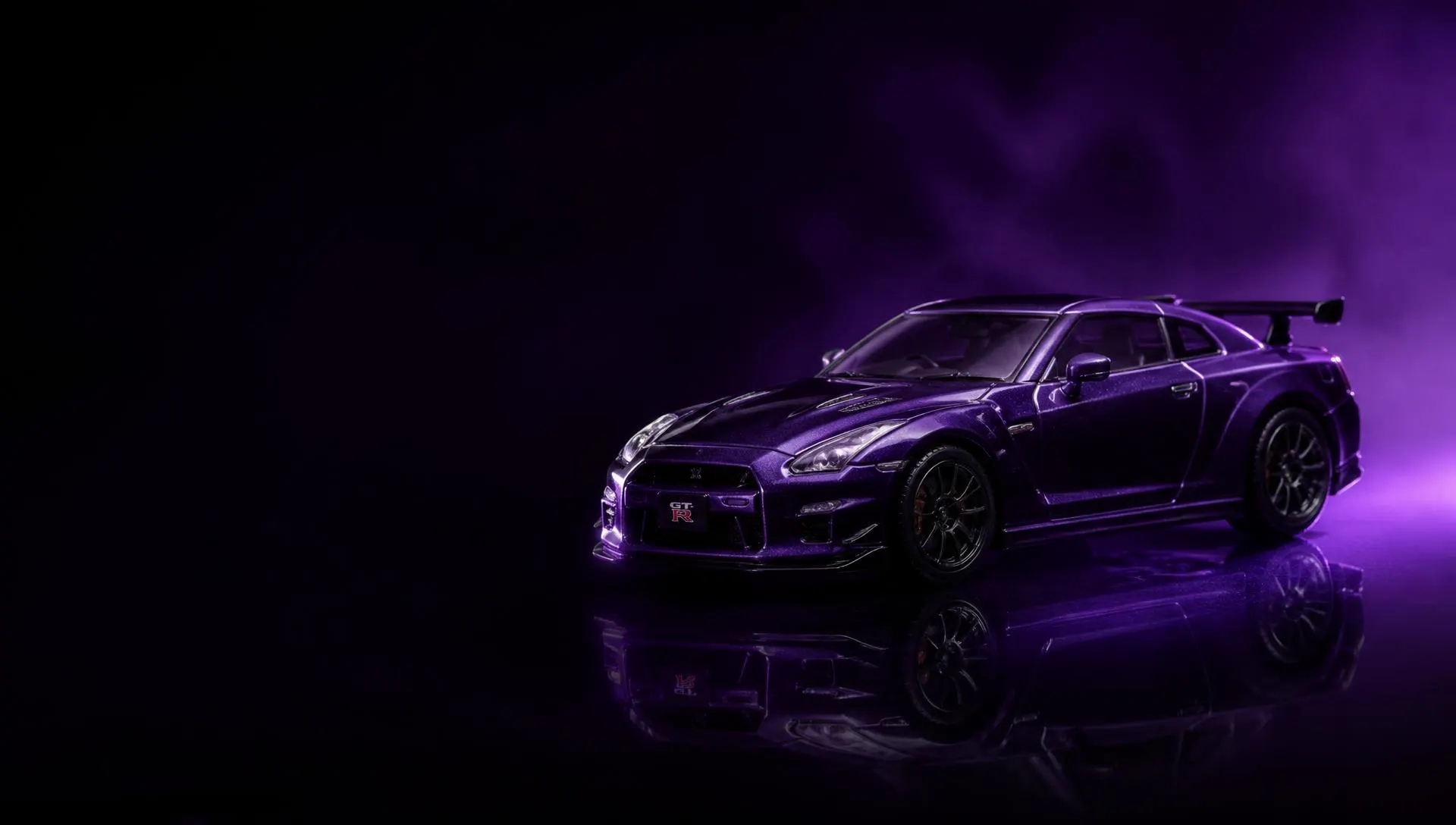 Purple die-cast GT-R model car under studio lighting